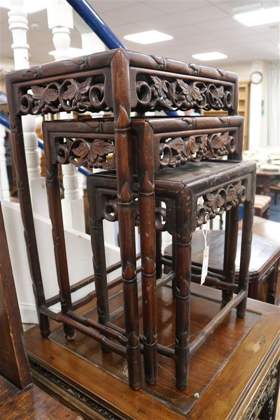 A Chinese nest of four carved hardwood tea tables (the largest a.f.) W.44cm